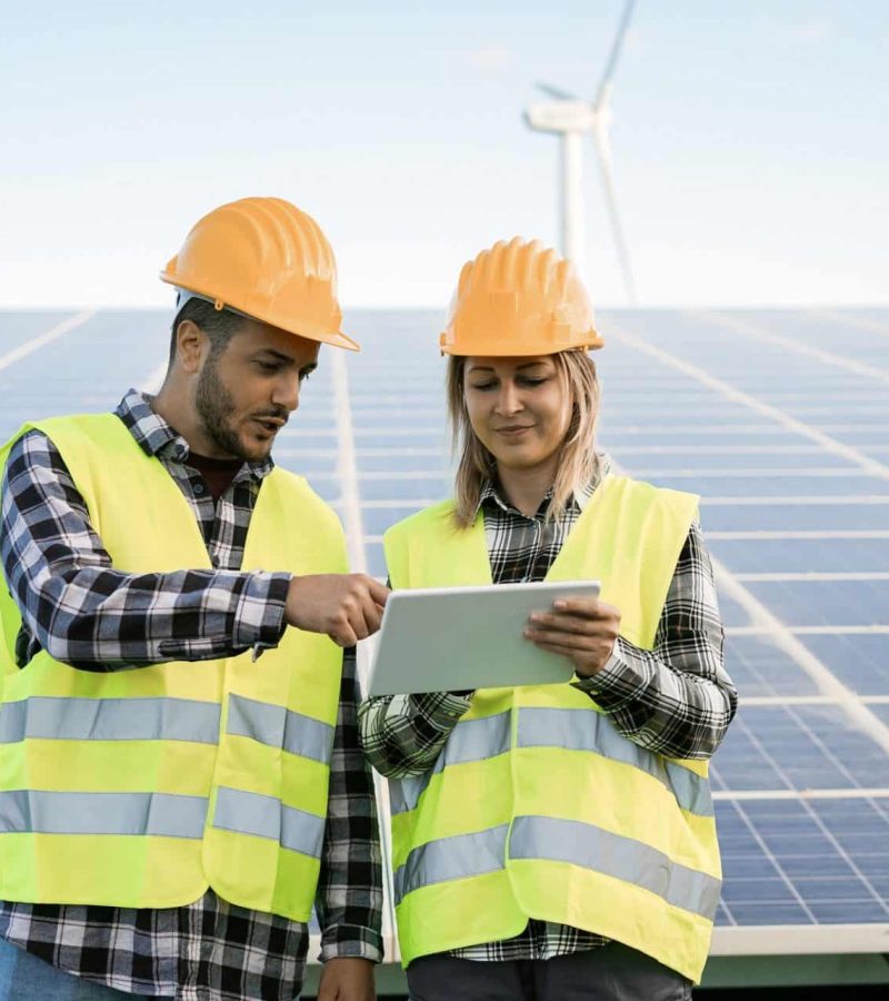 young-people-working-with-digital-tablet-at-renewable-energy-farm-focus-on-faces-e1641313571833